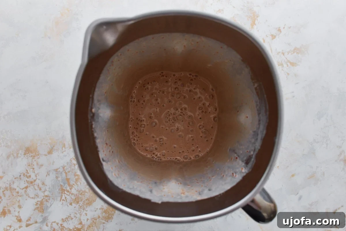 Blended date ice cream base in a blender pitcher, smooth and creamy with a light caramel color.