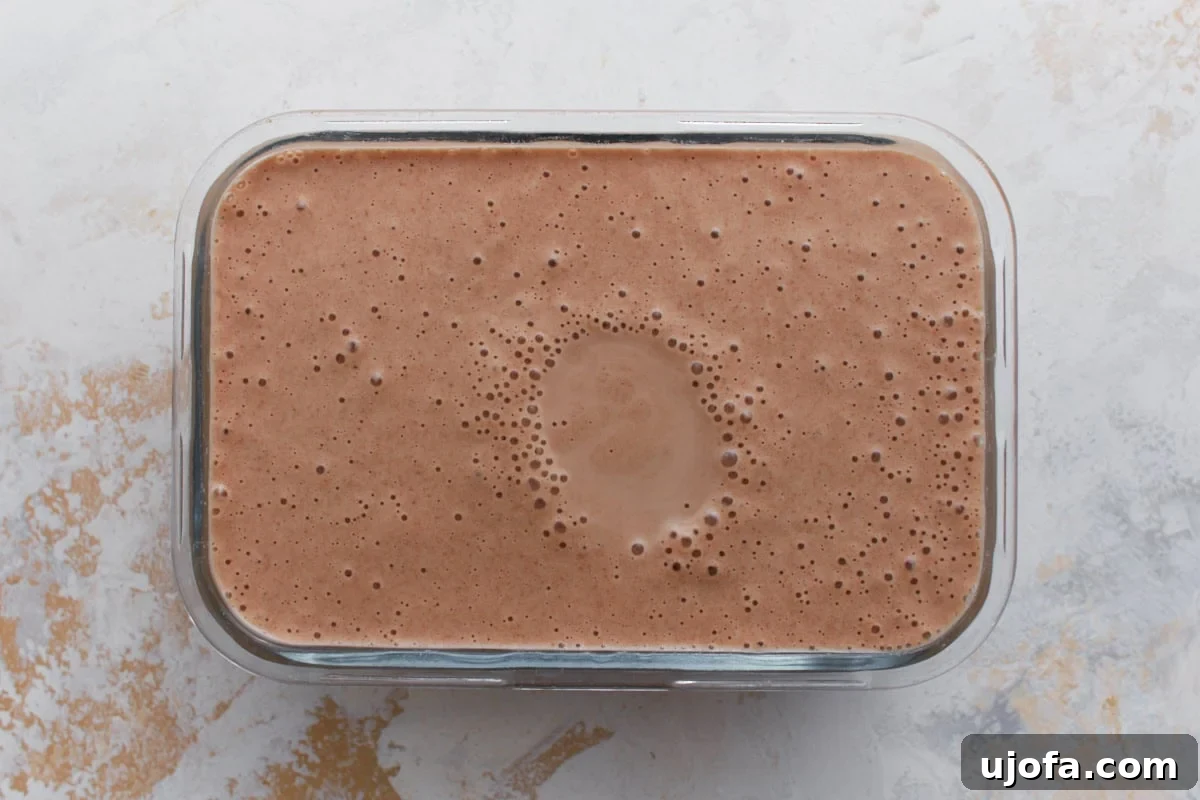 Homemade date ice cream mixture poured into a freezer-safe container before freezing.