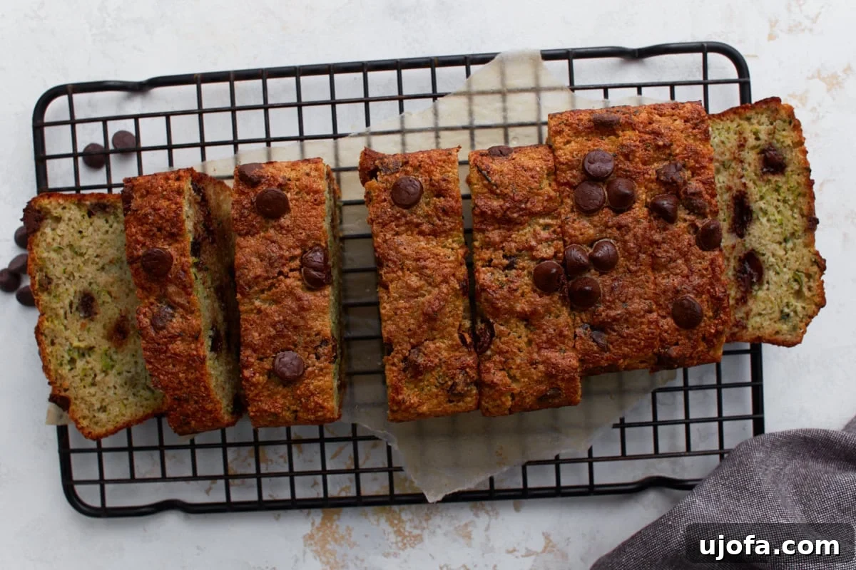 Overhead view of almond flour zucchini bread sliced into pieces on a black wire cooling rack
