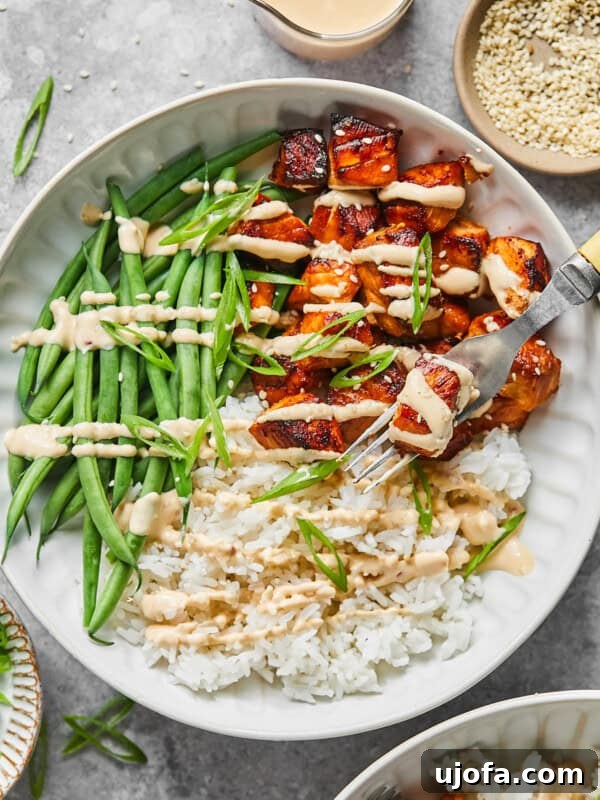 Protein-Packed Salmon Caesar with Creamy Dressing 15 bang bang salmon bites with sauce, rice and green beans in a bowl