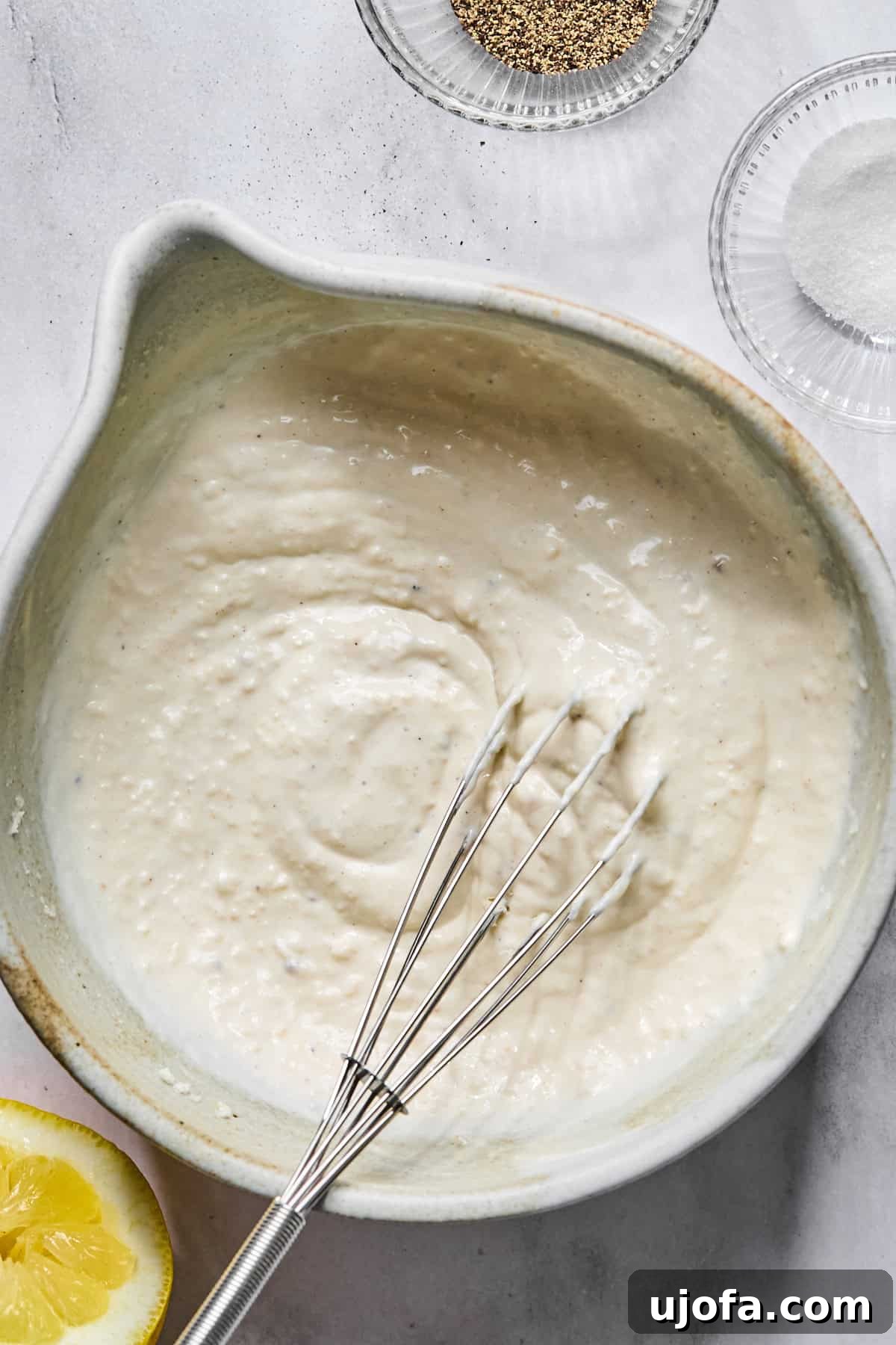 Protein-Packed Salmon Caesar with Creamy Dressing 4 homemade caesar dressing in a bowl with a small whisk