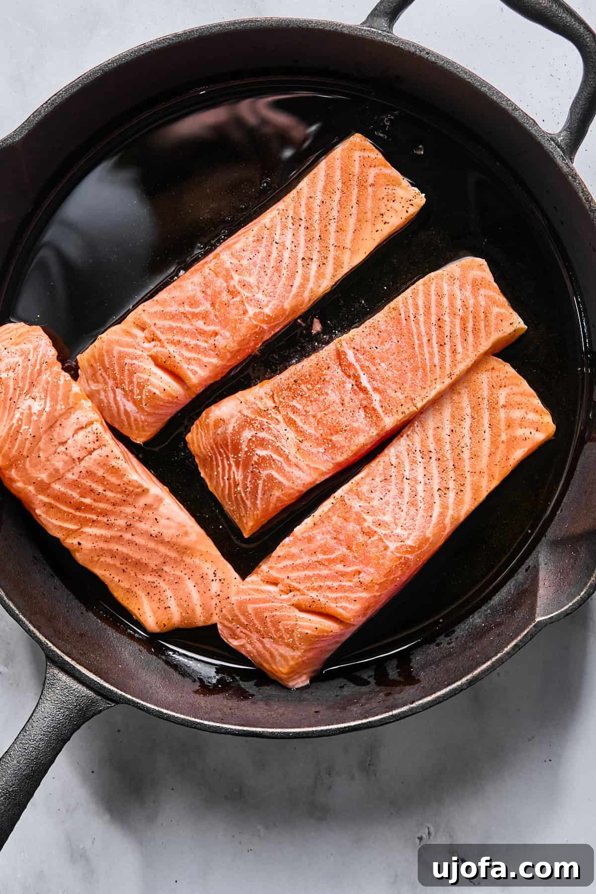 Protein-Packed Salmon Caesar with Creamy Dressing 6 salmon fillets in a cast iron skillet