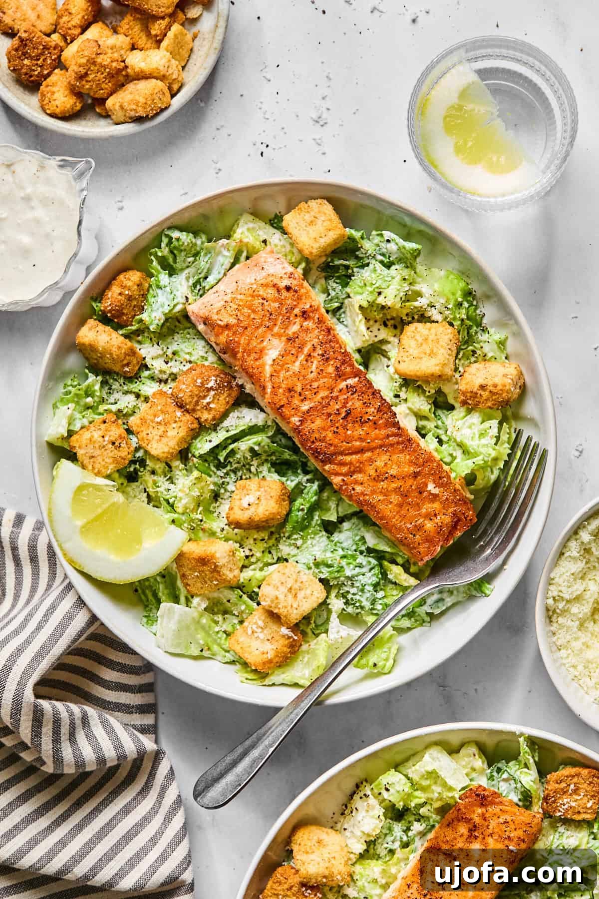 Protein-Packed Salmon Caesar with Creamy Dressing 10 salmon caesar salad in a bowl with croutons