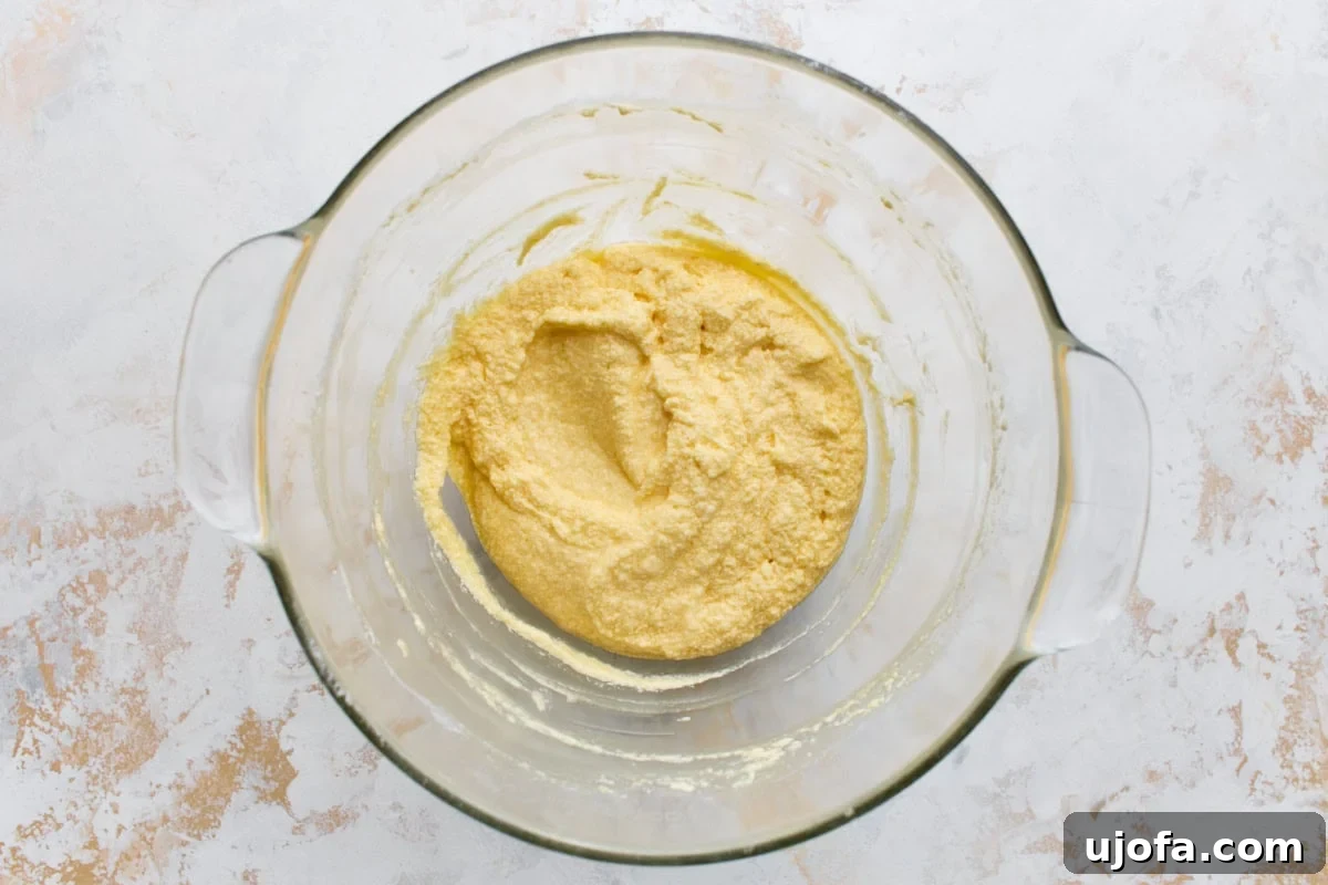 Classic Gluten-Free Victoria Sponge Cake Recipe 7 Cake batter in a glass bowl looking slightly curdled after the eggs are beaten in