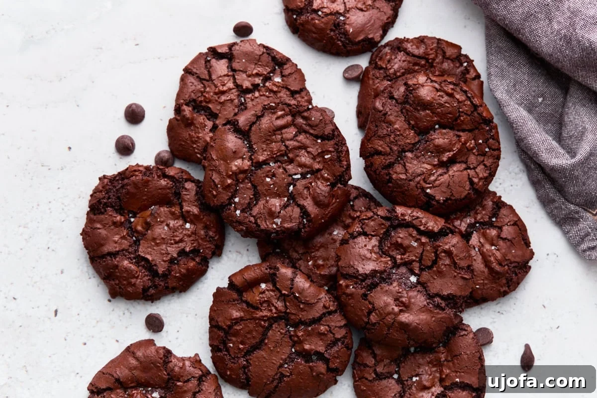 Fudgy Flourless Chocolate Cookies Gluten Free 11 Close-up of stacked flourless chocolate cookies showing their crinkled, crackled tops and fudgy edges.
