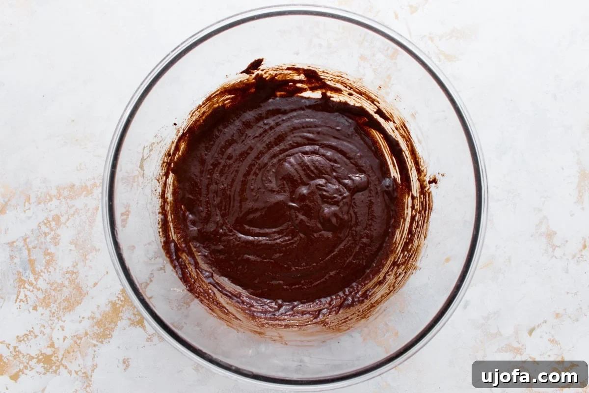 Fudgy Flourless Chocolate Cookies Gluten Free 6 Melted chocolate folded into the whipped egg mixture, forming a smooth, glossy batter.