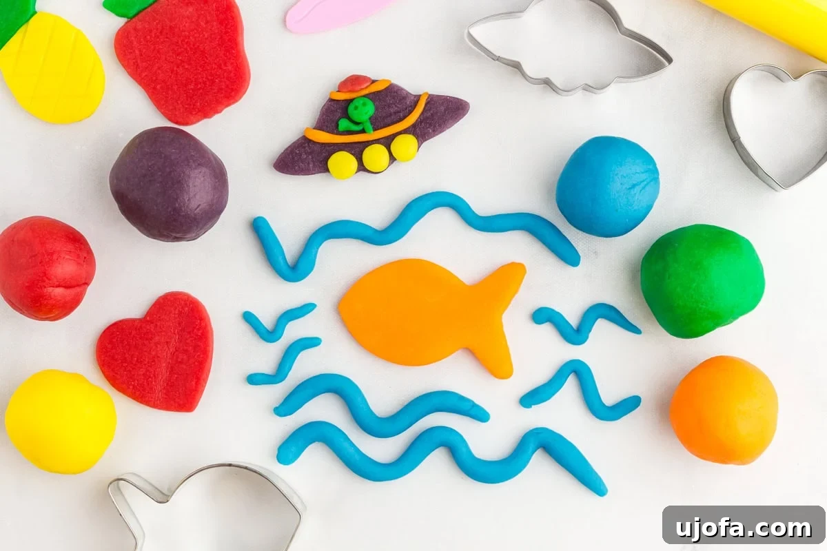 Homemade Gluten-Free Play Dough Recipe for Kids 3 a pineapple, strawberry, heart, fish, waves, and a UFO scene made from colored play doh