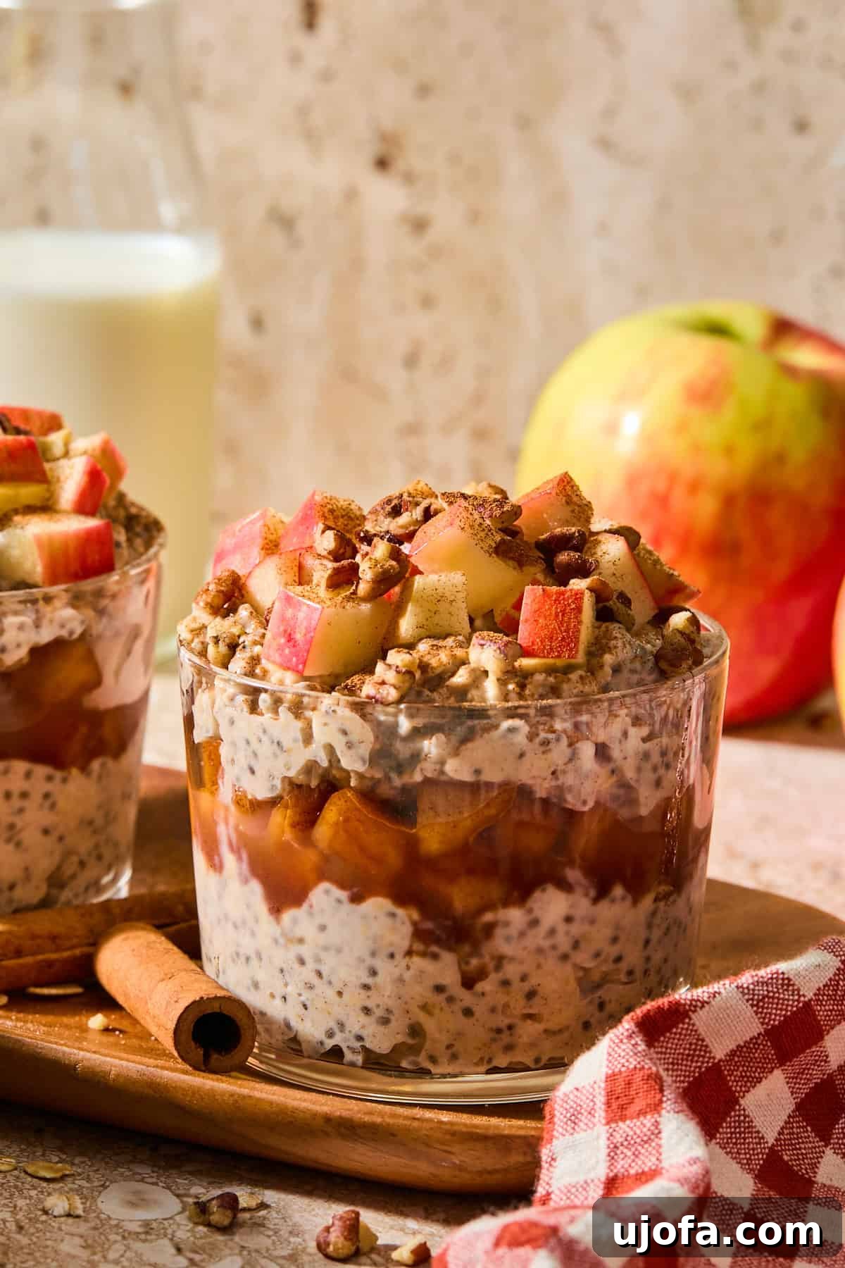 Protein-Packed Apple Pie Overnight Oats 2 apple pie overnight oats in a glass jar topped with apples and walnuts