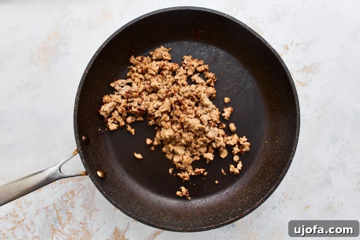 Make-Ahead Gluten-Free Breakfast Burritos 4 Browned breakfast sausage crumbles cooking in a nonstick skillet