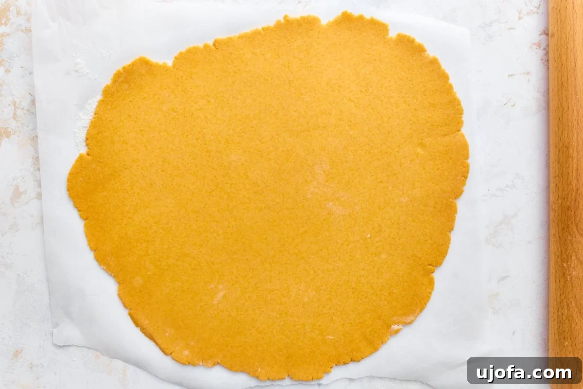 Homemade Gluten-Free Goldfish Crackers 7 Gluten-free goldfish cracker dough rolled thin on parchment paper with a rolling pin.