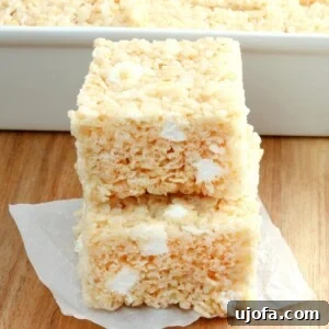 Delicious Gluten-Free and Dairy-Free Dessert Recipes 24 gluten-free rice krispies treats stacked with the pan of treats in the background