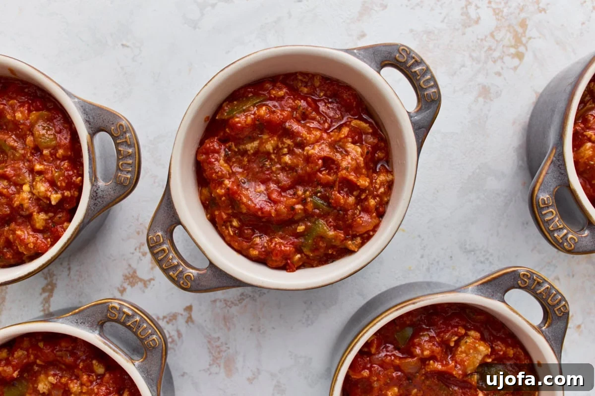 Crustless Pizza Bowl Recipe: Cheesy Pepperoni and Marinara 7 Sausage and marinara filling divided into five mini ramekins for crustless pizza bowls.